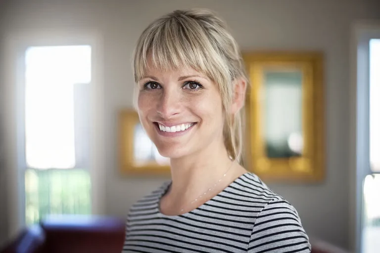 Smiling woman in a striped top at home
