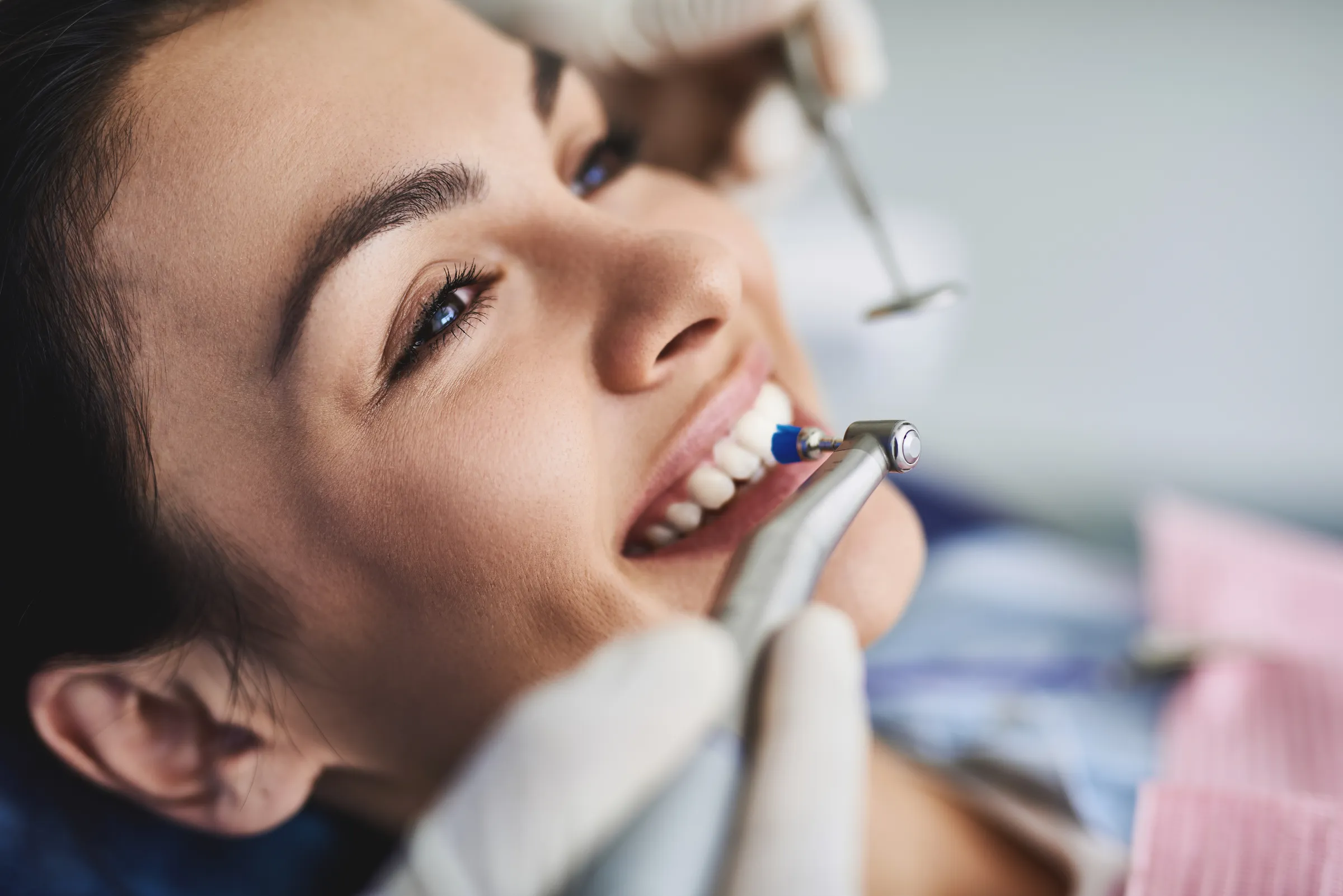 Patient in a dental chair during a scaling treatment