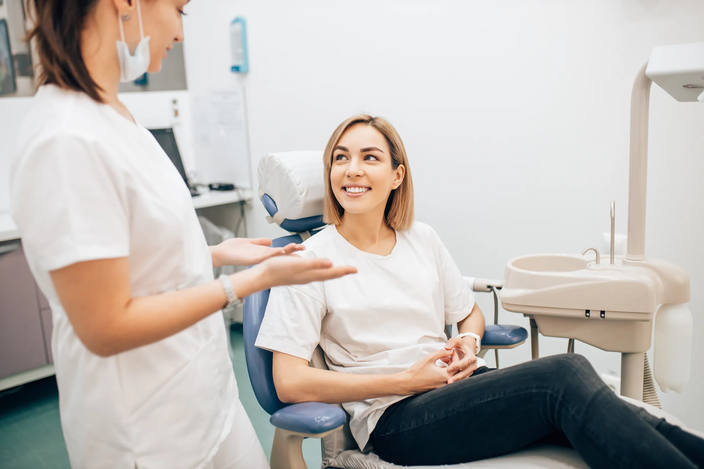 A patient talking with her dental team
